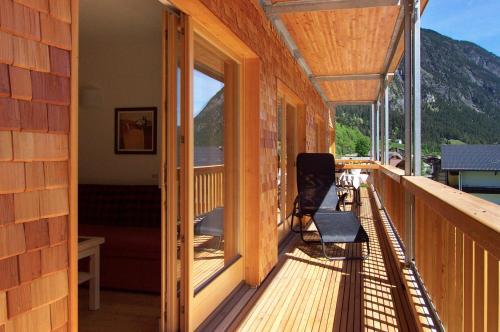 a balcony of a house with a view of the mountains at Biotel Bertel Naturappartements in Brand