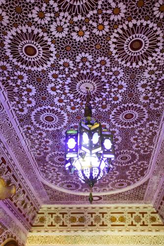 a chandelier hanging from the ceiling of a building at Riad Mehdi Meknès in Meknès