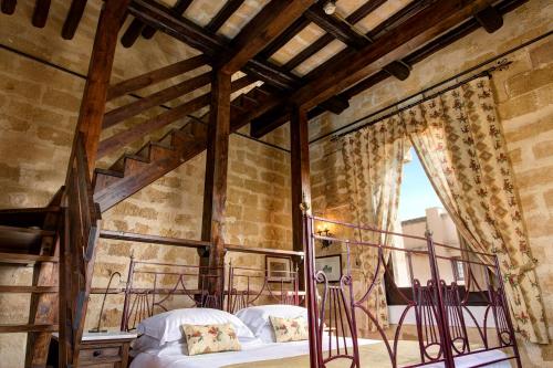 Postel nebo postele na pokoji v ubytování Hotel Baglio Oneto dei Principi di San Lorenzo - Luxury Wine Resort