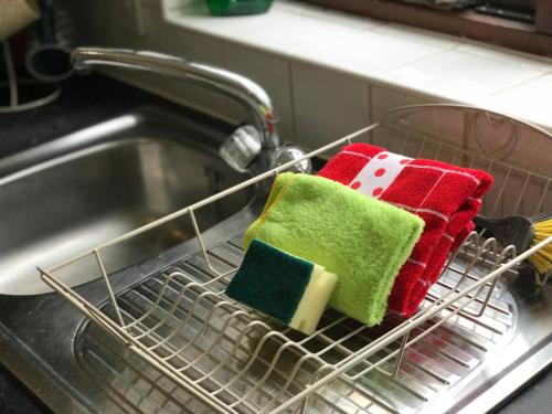 two towels in a dish rack in a sink at Swale Corner in Wellingborough