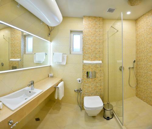 a bathroom with a sink and a toilet and a shower at Varchev 1 in Varna City
