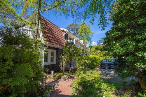 a house with a car parked in front of it at Hotel Im Schwedischen Hof in Binz