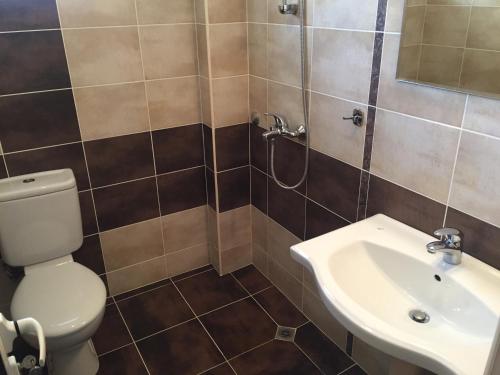 a bathroom with a toilet and a sink at Guest House Gloria in Nesebar