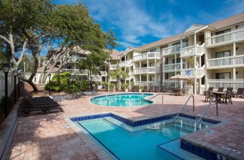 a swimming pool in front of a apartment building at Caribbean Resort Myrtle Beach in Myrtle Beach