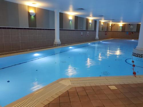a large indoor swimming pool with blue water at MILL Hotel & Spa in Chester