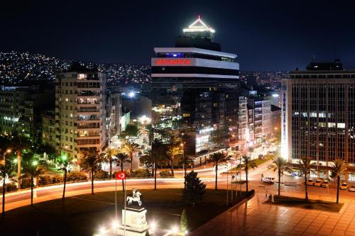 a view of a city at night with buildings at Mövenpick Hotel Izmir in Izmir