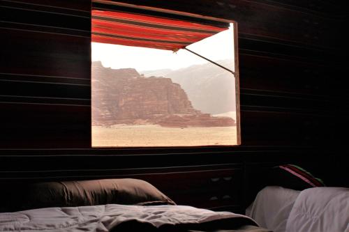 a window in a room with a view of the desert at Wadirum sunrise camp in Wadi Rum