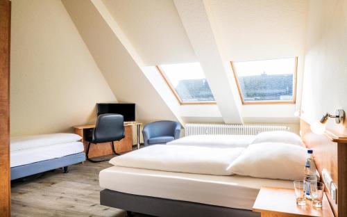 En eller flere senger på et rom på Schroeders City-Style-Hotel