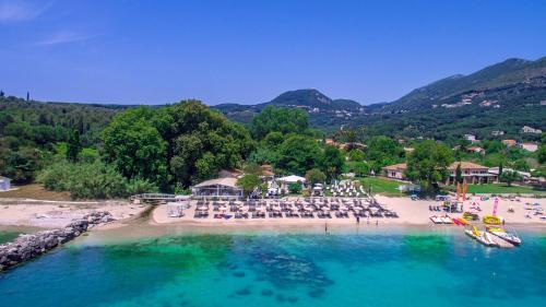 an aerial view of a beach with chairs and umbrellas at Cape North West in Parga