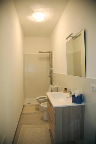 a bathroom with a sink and a toilet and a mirror at DOLCE VITA in Tempio Pausania
