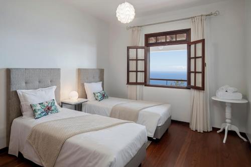 pokój hotelowy z dwoma łóżkami i oknem w obiekcie Southern Sunny House by An Island Apart w mieście Calheta