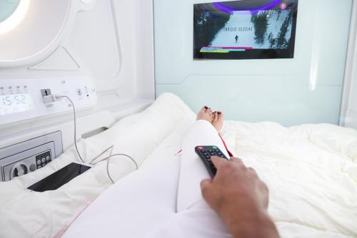 Postel nebo postele na pokoji v ubytování El Prado Capsule Hostel