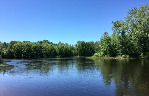 a river with trees on the side of it at Quality Inn Mont-Laurier in Mont-Laurier