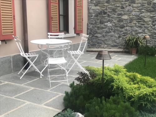 a patio with a table and chairs in front of a building at HOTEL AD Residence in Bormio