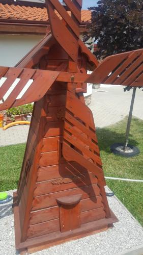 a wooden bench sitting on top of the grass at Penzion Mirabel in Bešeňová