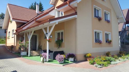 a house with flowers in front of it at Penzion Mirabel in Bešeňová