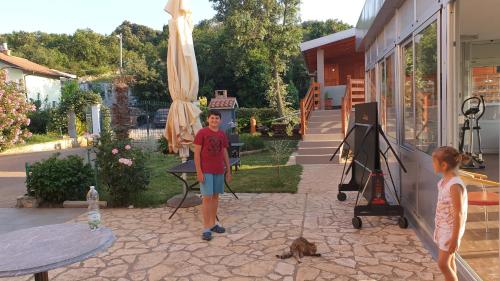 a boy and a girl standing outside of a house at Apartments Šeherzada in Pula