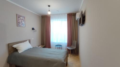 a hotel room with a bed and a window at Espresso in Myrhorod