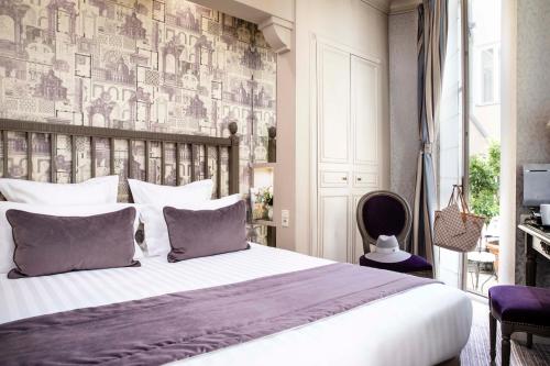 a bedroom with a large bed and a wall mural at Arioso in Paris