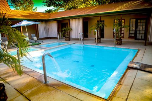 a large blue swimming pool with a fountain at Makhato Bush Lodge 111 in Bela-Bela