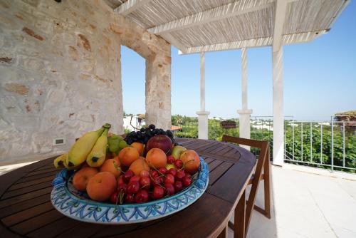 a bowl of fruit on a table on a porch at Villa Belvedere in Ostuni