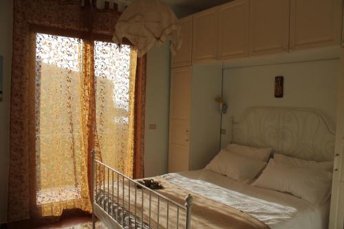 a bedroom with a bed and a large window at Villa Flora in Vico Equense