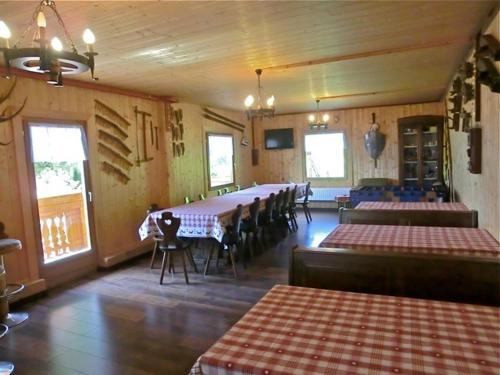 a room with rows of tables and chairs in a restaurant at Virtus Et Otium - Feldererhof in Vipiteno