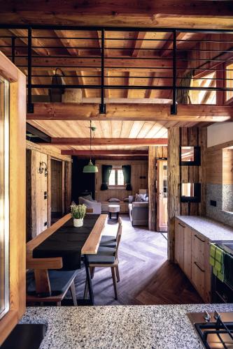 a living room with a table and a couch at Baita Valon - Alpine Hideaway in Comano Terme
