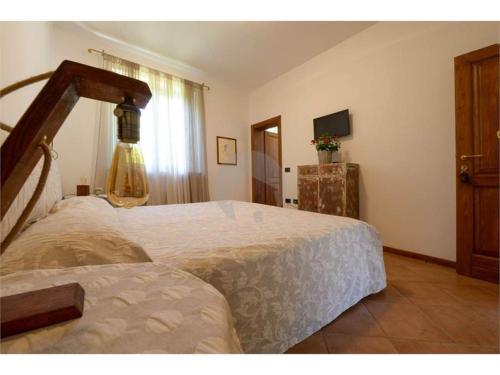 a bedroom with a large bed and a window at Agriturismo Ca' Andreana in Urbino