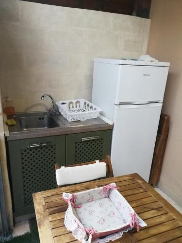 a kitchen with a sink and a white refrigerator at Villa Favignana in Favignana
