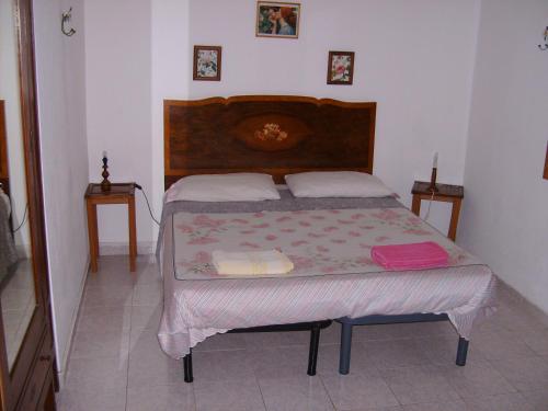a bed in a bedroom with two pillows on it at Bed & Breakfast 5 Di Spade in Gioiosa Marea