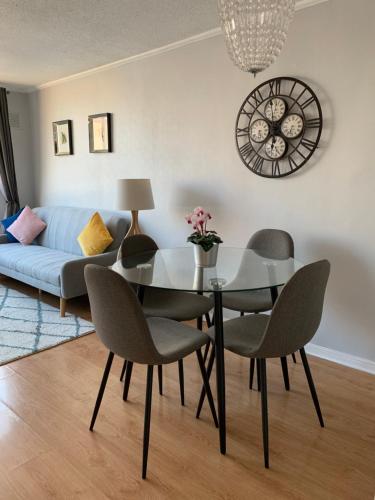 a dining room with a glass table and chairs at Stay Santiago Lastarria Bellas Artes in Santiago