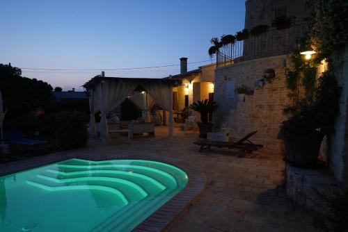 a swimming pool in the middle of a patio at Villa Belvedere in Ostuni