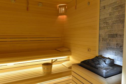 a sauna with a bench and a bucket in it at Wyndham Grand Istanbul Europe in Istanbul