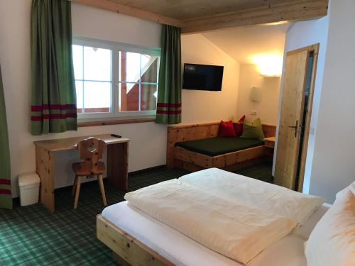 a hotel room with a bed and a couch at Heisshof in Schladming