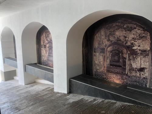a room with a brick fireplace with three shelves at Hotel Maria del Rocio in Veracruz
