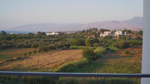 a view from the balcony of a house in a field at Panoramic sea view apartment in Polis-Latchi in Polis Chrysochous