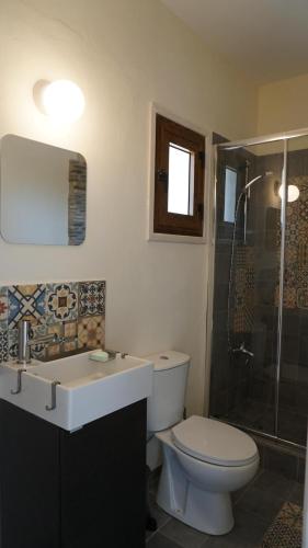 a bathroom with a toilet and a sink and a shower at Panoramic sea view apartment in Polis-Latchi in Polis Chrysochous