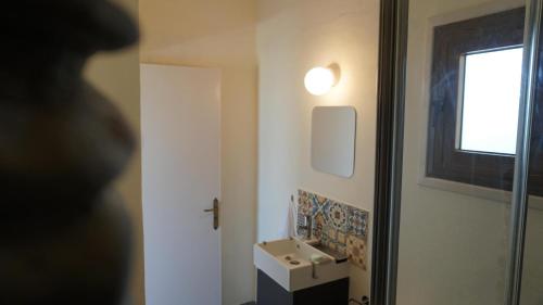 a bathroom with a sink and a window at Panoramic sea view apartment in Polis-Latchi in Polis Chrysochous