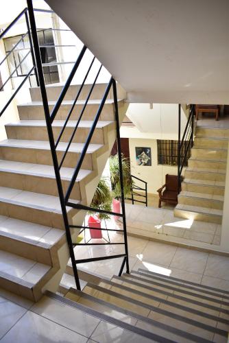 a staircase in a building with a stair case at Hotel Acuario in Churín