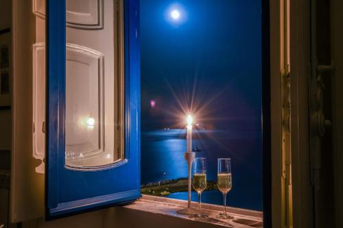 two glasses of wine sitting on a window sill at Suite Picasso in Amalfi