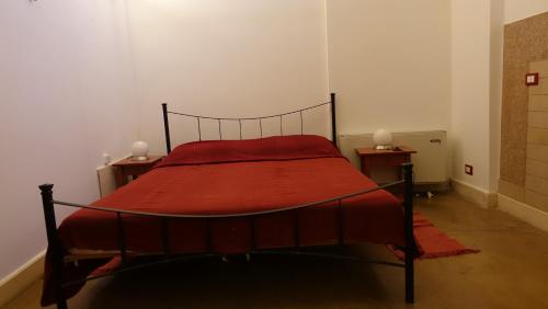 a bedroom with a bed with a red blanket at Masseria Donna Laura di Adriana Giangrande in Arnesano