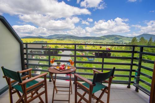 a balcony with a table and chairs and a view at Hotel Polar Star in Žabljak