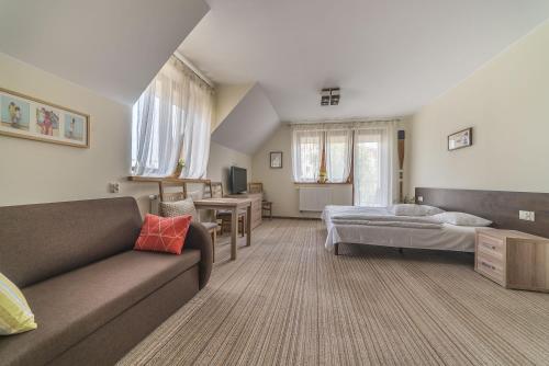 a living room with a couch and a bed at Willa Vela in Władysławowo