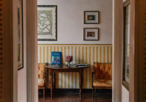 a room with a table and a chair and a table and chairs at Hotel Club i Pini - Residenza d'Epoca in Versilia in Lido di Camaiore