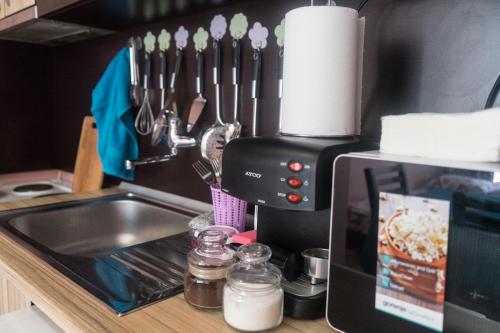 a kitchen counter with a coffee maker next to a sink at Apartment Eve in Varna City