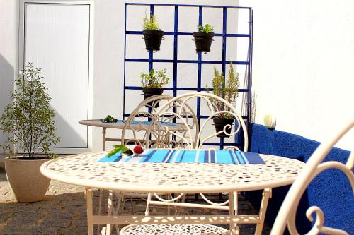 a table and chairs in a patio with potted plants at Casa do Salgueiral Douro in Peso da Régua