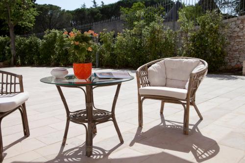 a table and two chairs and a table and a chair at Villa Rosato in Selva di Fasano