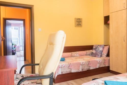 a living room with a couch and a chair at Apartment Eve in Varna City