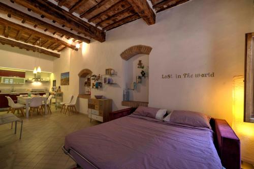 a bedroom with a bed and a dining room at Cozy Apartment in the heart of Siena in Siena